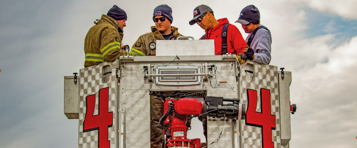 Firemen using fire equipment.