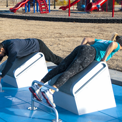 2 people doing exercises on Fitness Court